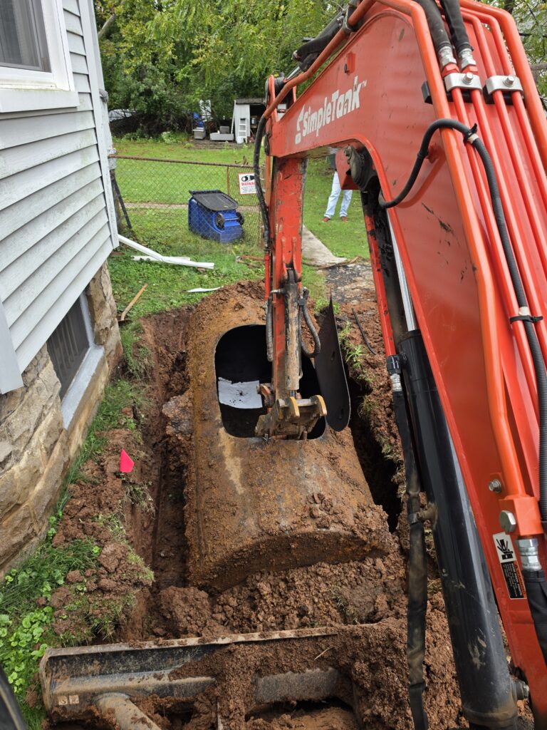 Simple Tank Services exposing an underground oil tank beside a Newark, New Jersey home.